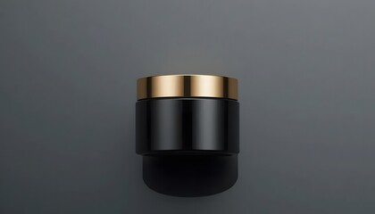 Elegant black matte cosmetic jar with golden cap, top-down view, clean background