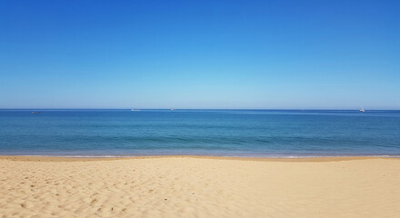 Scenic beach landscape with natural cloud formations and open sky above calm sea waves, showing a peaceful coastline and tranquil atmosphere, perfect for travel and nature concepts