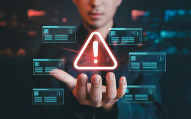 A businessman's hand displays a digital warning alert signifying data breach risk, cybersecurity threat, and urgent system failure requiring immediate attention to prevent significant losses.
