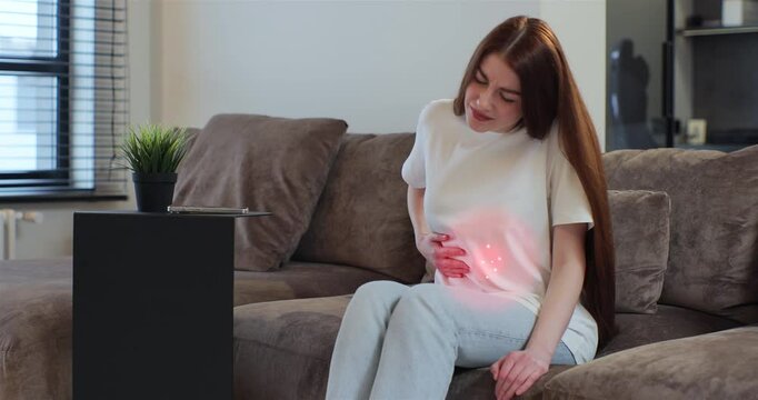 Young woman feeling abdominal, ulcer in her tummy, or menstrual pain at home. 3d animation with red pulsating sore zone of problem area.