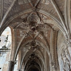 A large ornate ceiling with a clock