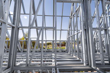 New residential construction home metal framing against a blue sky. Light gauge steel framing...