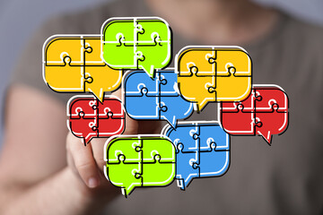 Colorful puzzle pieces forming speech bubbles, symbolizing teamwork and communication.