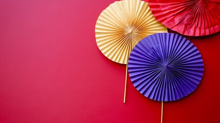 Colorful Paper Fans on Red Background Festive Decoration