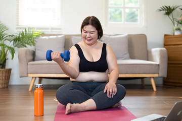 Strength Training at Home. Plus-size woman lifting dumbbell.