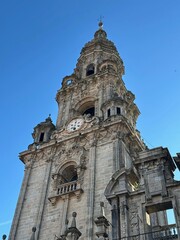 A large stone building with a clock tower with Dresden Frauenkirche in the background