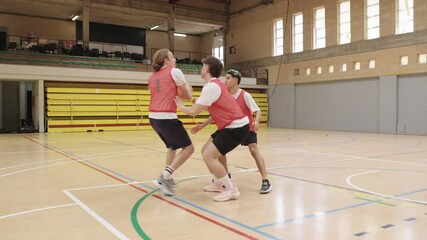 Basketball players training, dribbling, and shooting in a gymnasium - Powered by Adobe