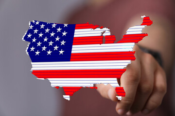 High-quality stock photo of a hand interacting with a digital US map designed with the American flag.