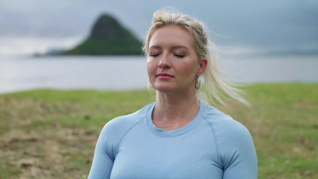 Female deep breathing in fitness attire, close up