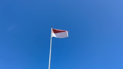 Indonesia flag on blue sky - Powered by Adobe