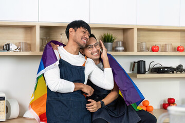 LGBT Couple Embracing with Pride Flag in Cozy Kitchen