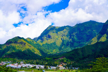 A view of the green landscape of the Rinjani volcano in summer. Farmland view from Selong Hill, Sembalun, Lombok, West Nusa Tenggara, Indonesia.