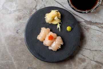 Fresh sushi arranged artfully on a black plate captures the essence of Japanese cuisine