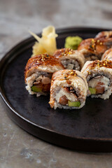 A beautifully arranged platter of sushi rolls features intricate flavors and textures, accompanied by ginger and wasabi, set against a minimalist backdrop that enhances its appeal