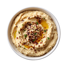 A top view of a bowl of hummus topped with olive oil spices and parsley in a white bowl on black