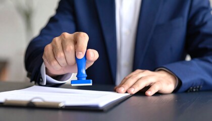 Hand man stamping documents notary public in office. Businessperson stamping approval of work finance banking or investment marketing documents on desk.
