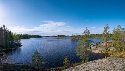 Fototapeta premium view of lake meiko area in spring rocks pine trees and lake kirkkonummi finland