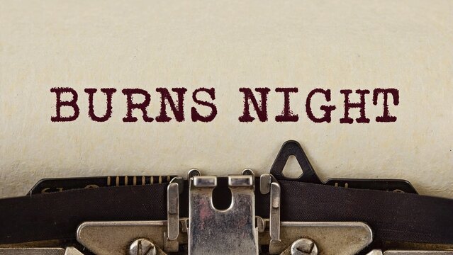 Close-up of typewriter typing the words Burns Night on paper, related to the Scottish holiday celebration.