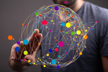 Abstract image of a person interacting with a colorful, interconnected data sphere, representing...