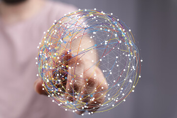 Abstract image of a hand interacting with a digital sphere, representing global network connections and data visualization.