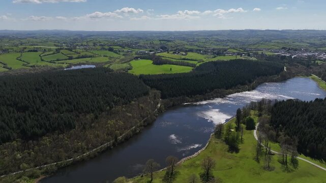 Bellamont House, County Cavan, Ireland, April 2023. Drone pulling back over lush Irish countryside, stunning views of dense forests, serene lakes, rolling hills and heritage.