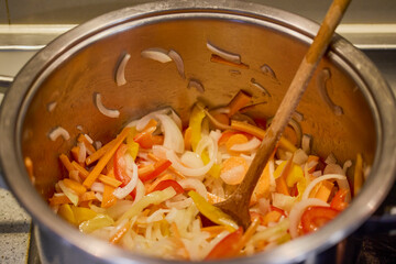 mixed vegetables with bacon in a wok put to cook