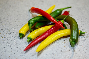 mixed chili peppers in three colors on a table