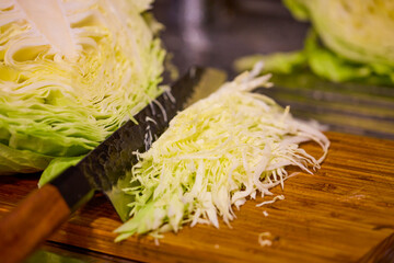 finely chopped fresh white cabbage on a wooden board
