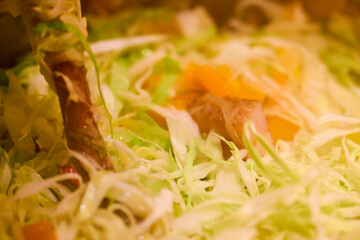 mixed vegetables with bacon in a wok put to cook