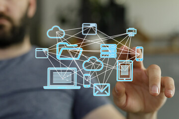 Image depicts a person interacting with a digital network of devices and cloud storage.