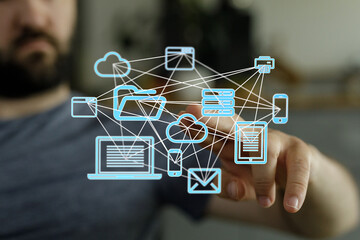A man interacts with a visual representation of a cloud computing network, showcasing data...