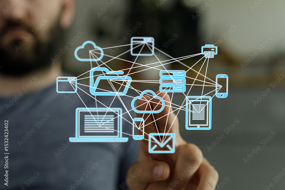 Poster Stock photo of a man interacting with a digital network of devices, showcasing cloud computing and data connectivity.