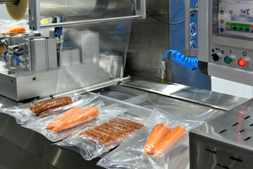High-performance machines are wrapping food products food in production lines on conveyor belts, food production industry
