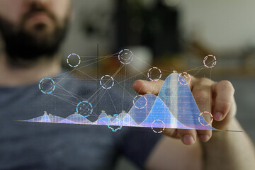 Close-up of a man's hand interacting with a holographic display showing data charts and graphs,...