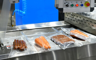 High-performance machines are wrapping food products food in production lines on conveyor belts, food production industry