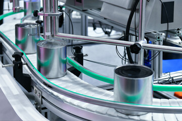 Canned food products on conveyor belt in distribution warehouse. parcels transportation system concept