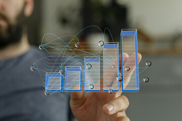 A man's hand interacts with a digital bar graph, showcasing data analysis and visualization.