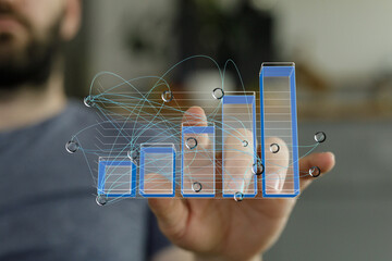 A hand interacts with a digital bar chart, visualizing business growth and data analysis.