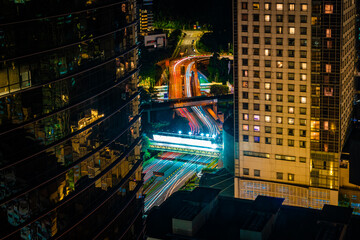at night, long exposure of KL traffic between two buildings