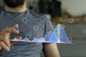 Close-up of a man interacting with a holographic graph, showcasing data analysis and technology.
