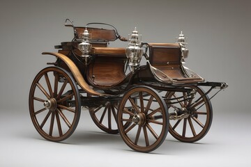 Fototapeta premium Elegant carriage featuring wooden wheels and polished metal accents against a neutral backdrop.