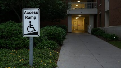 Access ramp sign indicating wheelchair accessibility near building entrance  
