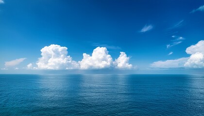 white cumulus clouds in blue sky over sea landscape big cloud above ocean water panorama horizon beautiful tropical sunny summer day seascape panoramic view cloudy weather cloudscape copy space