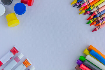 Crayons, paints, plasticine, gouache for drawing, photo background, objects for education, photo...