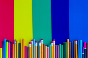 Obraz premium Multicolored background, paper, pencils, different colors, pencils for drawing, photo background, training, red, yellow, blue colors