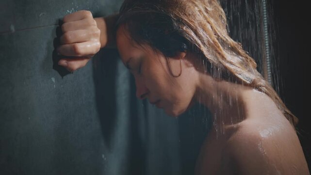 Natural beauty woman crying standing under the shower drops of water flowing down the face wet hair, mood depression sadness loneliness emotion. Adult Girl sad tear-stained face eyes closed. video 4k.