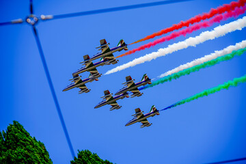 Aerobatic team flying in formation leaving colorful smoke trails