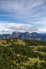 Alpine scenery on a serene day, showcasing the grandeur of nature and the human trace of a path.