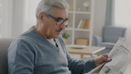 serene retirement captured in a cozy home environment, where an elderly gentleman savors the simple pleasures of reading and sipping a warm drink