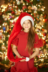 portrait of cute girl in red dress in new year decor